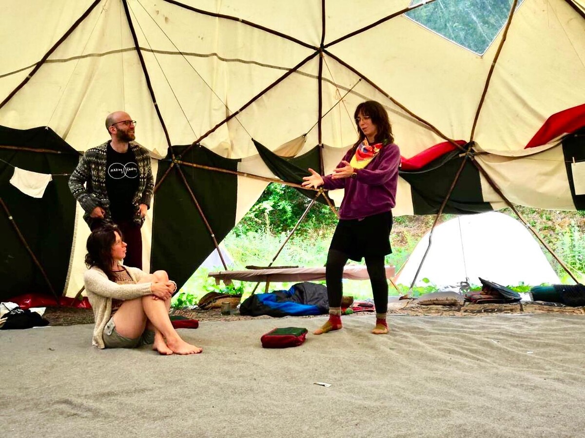 Three people in conversation together